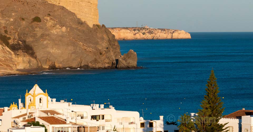 Praia da Luz with its striking black volcanic rock, Rocha Negra