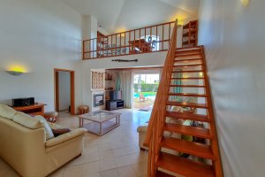 Helles Wohnzimmer mit Blick auf den Pool und Garten